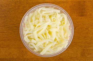 Shredded Mozzarella Cheese in a Plastic Container