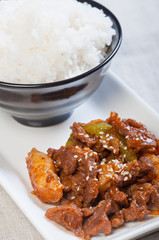 korean beef barbeque with rice cakes and rice on a side