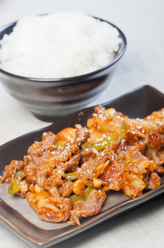 korean beef barbeque with rice cakes and rice on a side
