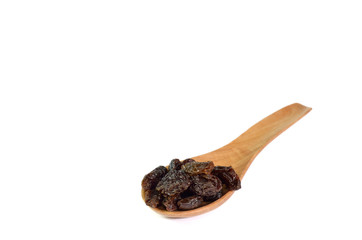 Raisin and wooden spoon isolated on white