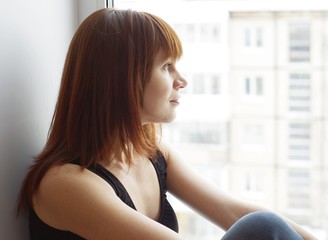 Portrait of woman at a window overlooking the next house