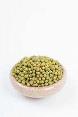 Green mung beans in bowl on white background