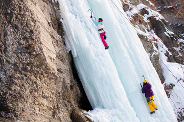 Man climbing frozen waterfall