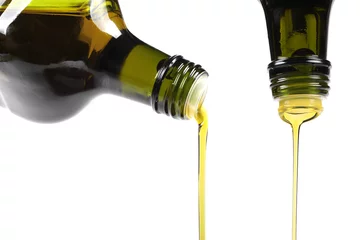 Fototapeten olive oil pouring from glass bottle isolated on white © ronstik