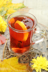 cup of hot drink and autumn leaves, close up