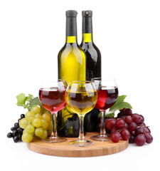 bottles and glasses of wine and assortment of grapes, isolated