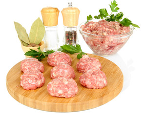 Raw meatballs with spices isolated on white