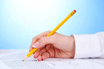 Closeup of businesswoman hand, writing on paper