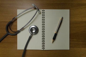 pen and stethoscope on book