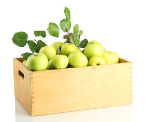 juicy apples with green leaves in wooden crate, isolated