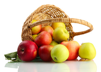 juicy apples with green leaves in basket, isolated on white © Africa Studio