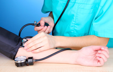 Blood pressure measuring on blue background