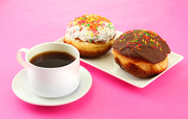 Tasty donuts on color plate on color background