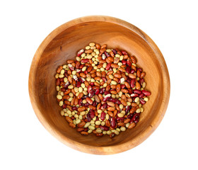 Beans in wooden bowl isolated on white