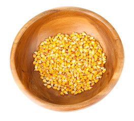 Corn in wooden bowl isolated on white