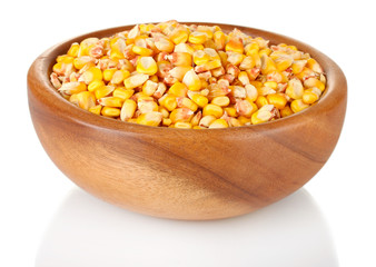 Corn in wooden bowl isolated on white