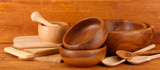Wooden kitchen utensils on wooden background