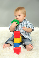 Little boy playing with multicolor blocks