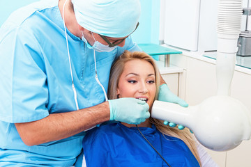 Dentist make jaw x-ray image for girl in dental clinic