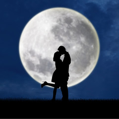 Couple in love on blue full moon silhouette