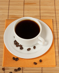 One white coffee cup and saucer on the table