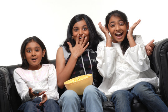 Group of girls  watching TV