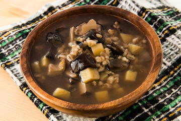 Mushroom soup in wooden plate