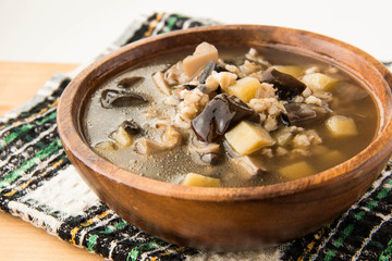 Mushroom soup in wooden plate