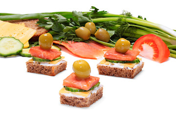 Light and tasty snack of bread, cheese, smoked salmon and olives