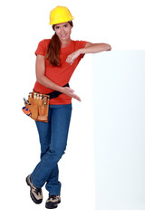 craftswoman presenting a blank ad board