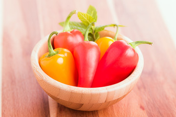 Group peppers on wood