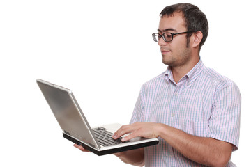 man with glasses working at a laptop