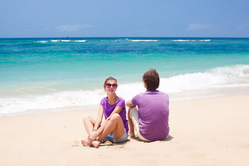 young beautiful couple on tropical bali beach.honeymoon