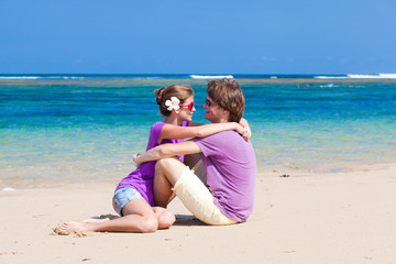 young beautiful couple on tropical bali beach.honeymoon