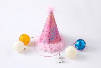 A cute party hat with colorful baubles and small bells