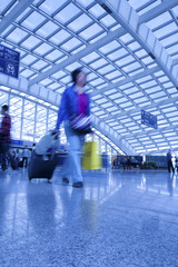 Passengers walk at the Beijing International Airport