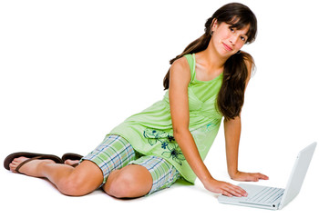 Obraz na płótnie Canvas Portrait of teenage girl using a laptop