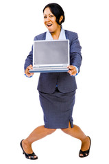 Smiling businesswoman holding laptop