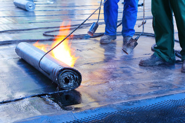 men Crout roof with hot tar