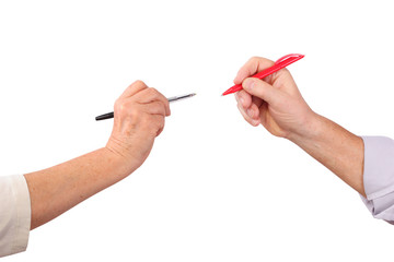 Two senior hands hold pens, isolated