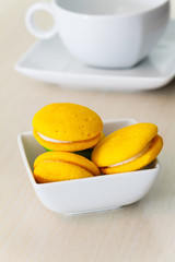 Round yellow marron cookies with lemon cream