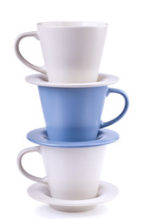 Three plates and coffee cups stacked together