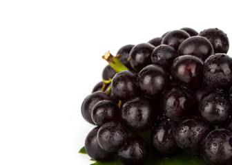 Red grape with green leaf  isolated on white background