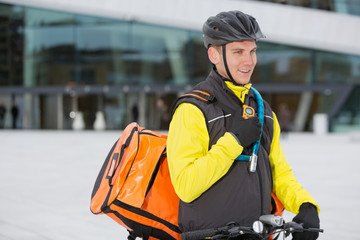Male Cyclist With Courier Delivery Bag Using Walkie-Talkie