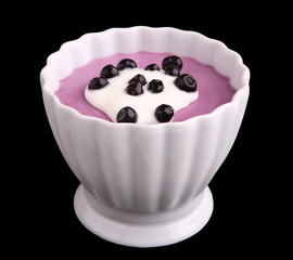 blueberries cream with yogurt isolated on black