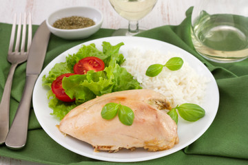 chicken with boiled rice and salad on the plate