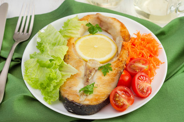 fish with lemon, lettuce, tomato and carrot