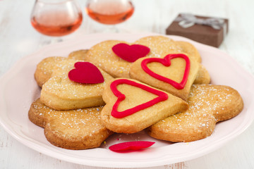 cookies on the plate with wine and box
