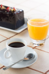 Breakfast with coffee, orange juice and plumcake