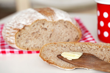 Spelt flour bread slice with butter at breakfast - 47437272
